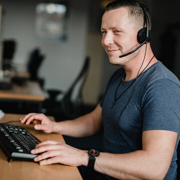 Ein Teilnehmer sitzt an seinem Arbeitsplatz und trägt sein Headset.